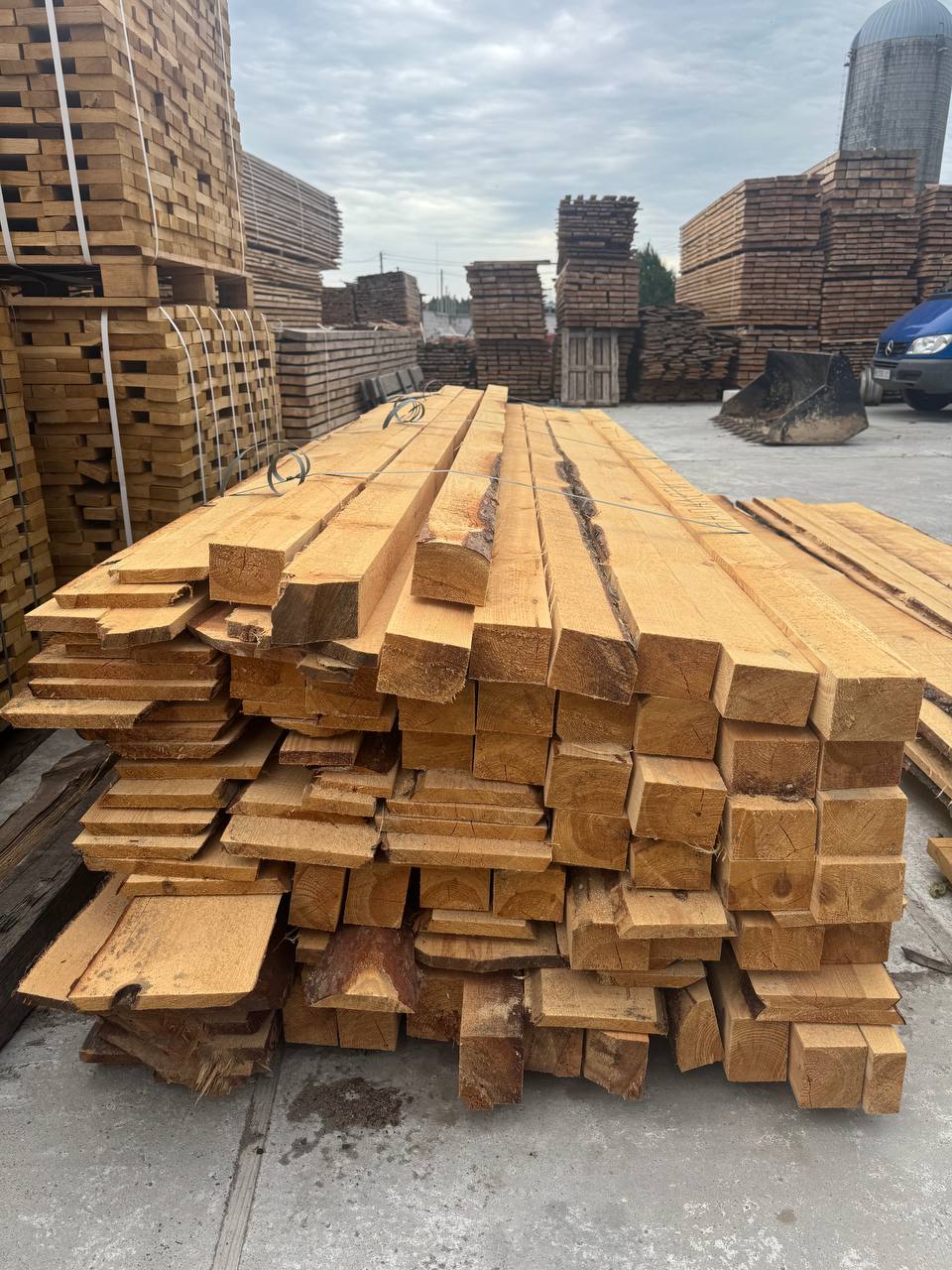Squared pine beams and boards stacked at the sawmill